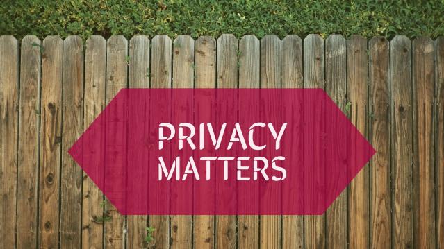 A wooden fence with a small amount of grass beyond it. A caption in a red box over the fence reads "Privacy Matters."