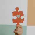 person holding orange puzzle piece